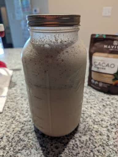 A half gallon mason jar cold cacao made with raw milk.