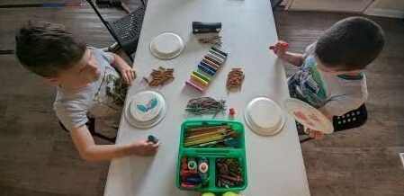 My boys making "tamborines" as one of the suggested activities from Gather 'Round curriculum.