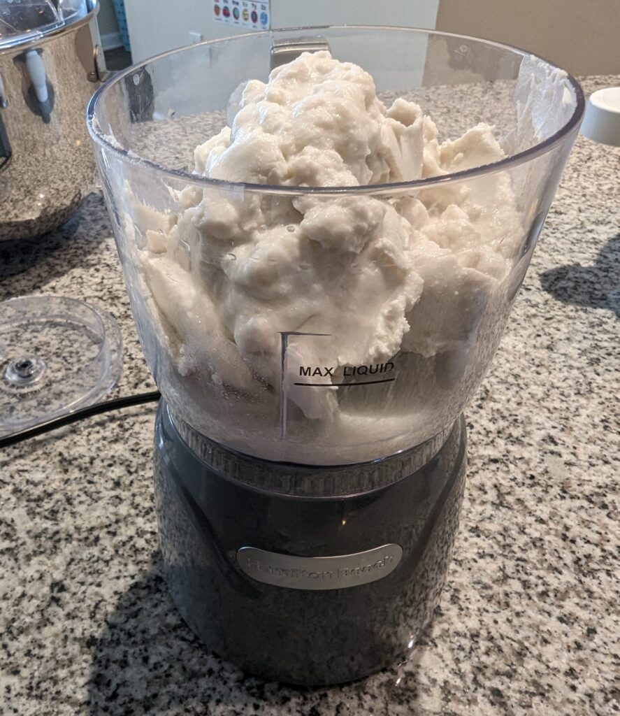 1 can of coconut cream added to the bowl of small food processor.